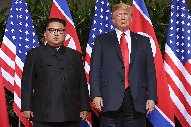 U. S. President Donald Trump stands with North Korea leader Kim Jong Un for a photograph at the Capella resort on Sentosa Island Tuesday, June 12, 2018 in Singapore. (AP Photo/Evan Vucci)


