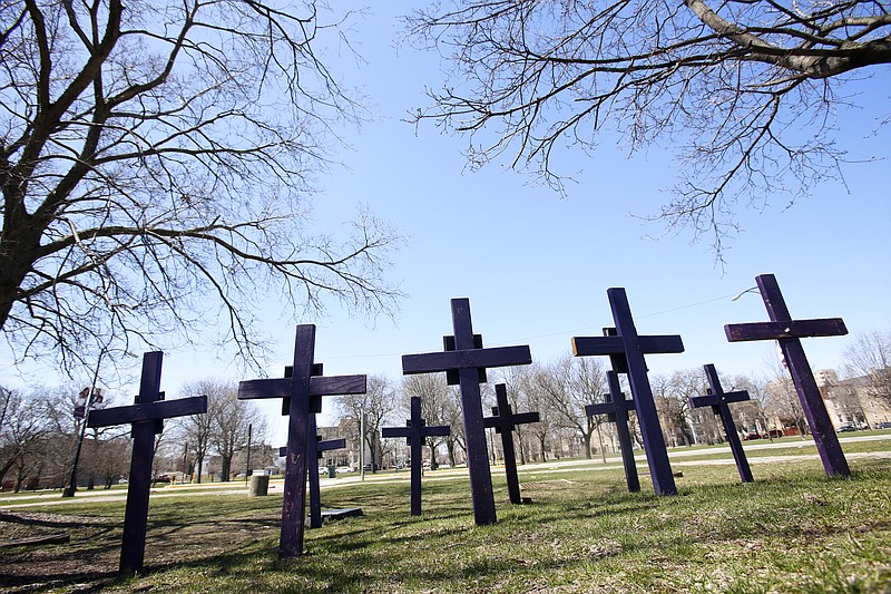 FILE - In this Thursday, April 19, 2018 file photo, crosses representing victims of gun violence stand outside Collins Academy High School in Chicago's North Lawndale neighborhood. 