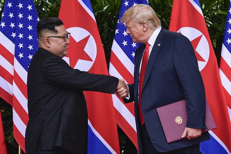 FILE - In this June 12, 2018, file photo, North Korea leader Kim Jong Un, left, and U.S. President Donald Trump shake hands at the conclusion of their meetings at the Capella resort on Sentosa Island in Singapore.