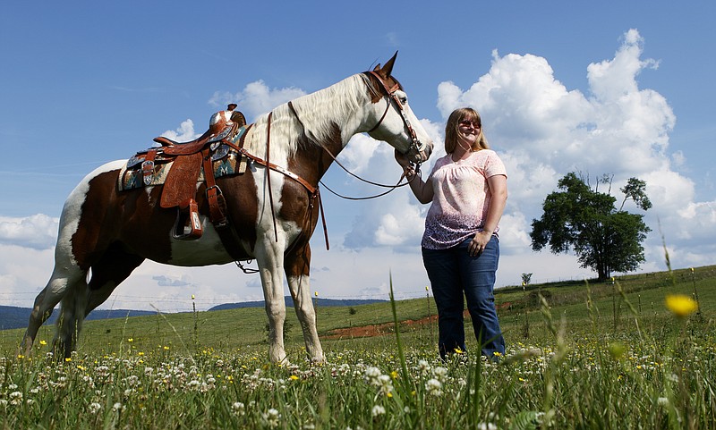 Staff photo by C.B. Schmelter / 
Berean Academy valedictorian Kobea Reynolds poses with her horse Rambling Girl at their home on Thursday, May 24, 2018 in Pikeville, Tenn.