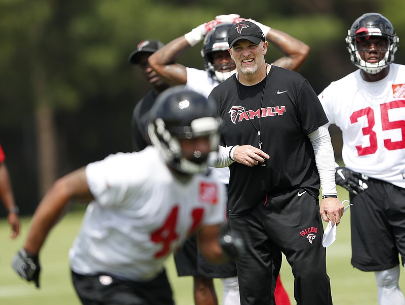 Atlanta Falcons coach Dan Quinn watches a drill during the team's minicamp Wednesday in Flowery Branch, Ga. What Quinn wasn't able to see at the practice was Julio Jones in action. The team's top wide receiver is sitting out the mandatory minicamp, apparently in a bid to restructure his contract.