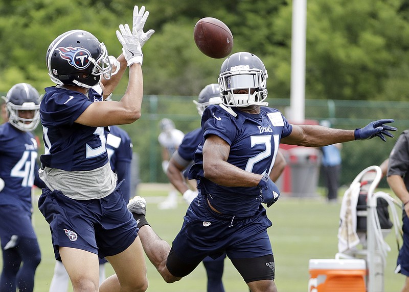 Malcolm Butler, right, knocks the ball away from fellow defensive back Jeremy Boykins during a drill at the Tennessee Titans' minicamp Wednesday in Nashville.
