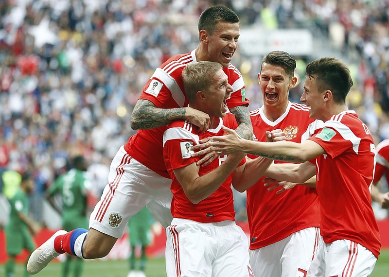 Russia's Yuri Gazinsky celebrates with teammates after scoring his country's first goal during a group stage match against Saudi Arabia to open the World Cup on Thursday at Luzhniki Stadium in Moscow.