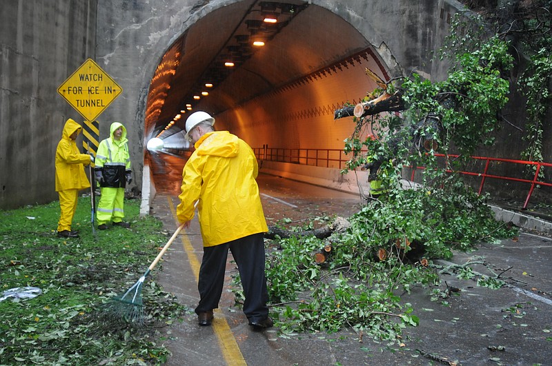 Workers clear a downed tree from in front of the McCallie Avenue Tunnel in this file photo. The McCallie and Stringers Ridge tunnels will close overnight Wednesday for cleaning, with the Bachman Tubes following on Thursday. 

