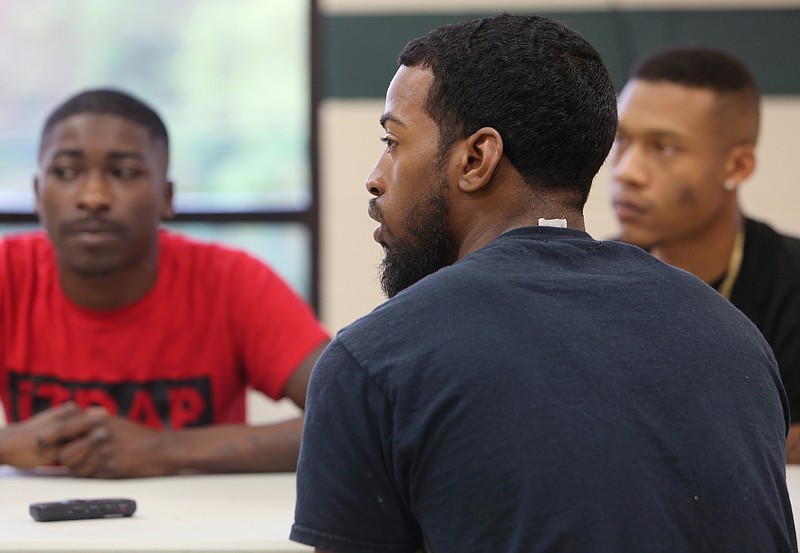 Brandon Woodruff with Fatherly Figure talks with other organizers about a kickball game that will be held today between Fatherly Figure and iTRAP.