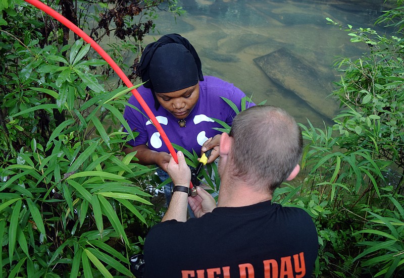 Mark Pace/Chattanooga Times Free Press — Chattanooga Girls Leadership Academy graduate Zainab Muhammad works with STEM teacher Chris Barnett to finish a solar powered pump irrigation system for a garden at Lula Lake Land Trust. Muhammad chose the task for her senior project and wanted to fully complete the installation before leaving for college.