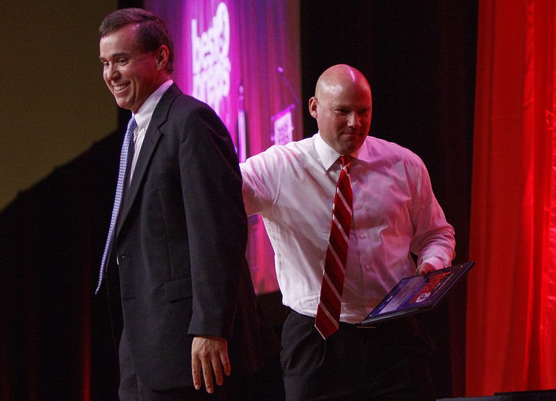 Baylor's Curtis Blair, right, gives a pat on the back to Times Free Press sports writer David Paschall after receiving the Scrappy Moore Coach of the Year award during the Best of Preps banquet Thursday night at the Chattanooga Convention Center.