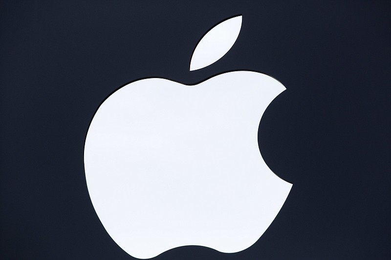 FILE - In this July 28, 2016 file photo, the Apple logo is shown on a sign hanging in front of a new Apple Store, in the Williamsburg section in the Brooklyn borough of New York. 
