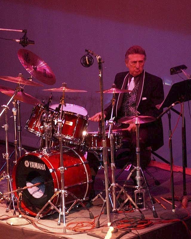 FILE- In this Oct. 16, 2004 file photo, longtime Elvis Presley drummer D.J. Fontana performs at the 50th anniversary celebration concert of Elvis Presley's first performance at the Louisiana Hayride in Sherveport, La. Fontana, the drummer who helped launch rock 'n' roll as Elvis Presley's sideman, has died at 87, his wife said Thursday, June 14, 2018. Karen Fontana told The Associated Press that her husband died Wednesday, June 13 in his sleep in Nashville. (Robert Ruiz/The Shreveport Times via AP)

