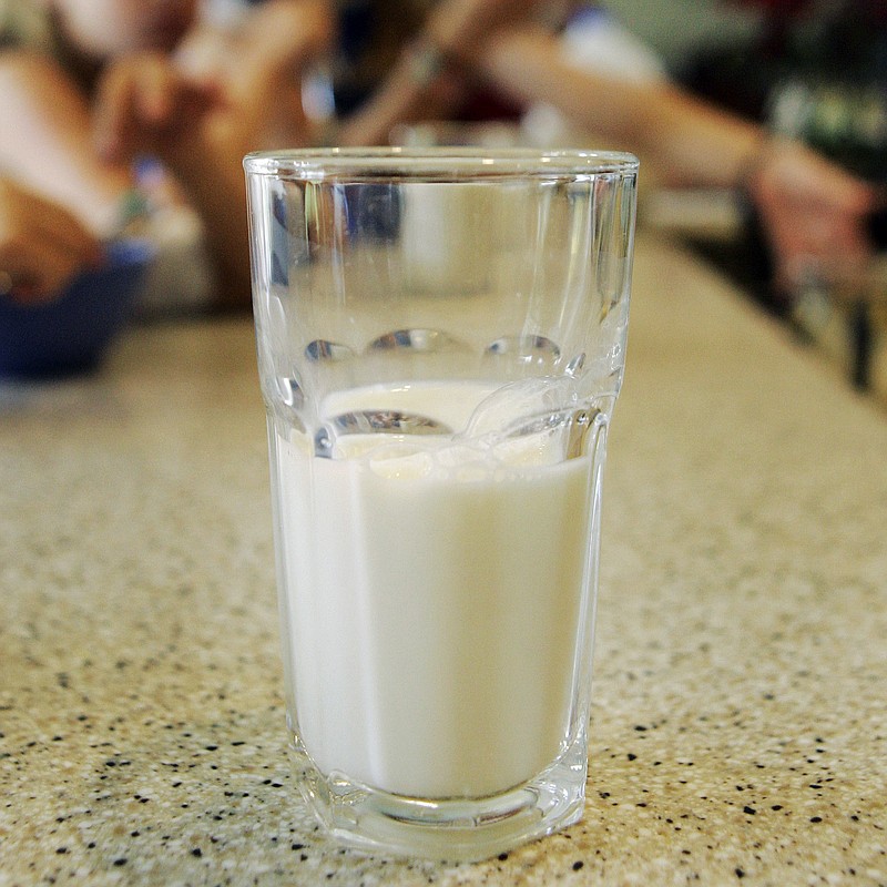 FILE - This June 8, 2007 file photo shows a glass of milk on a table during a family breakfast in Montgomery, Ala.