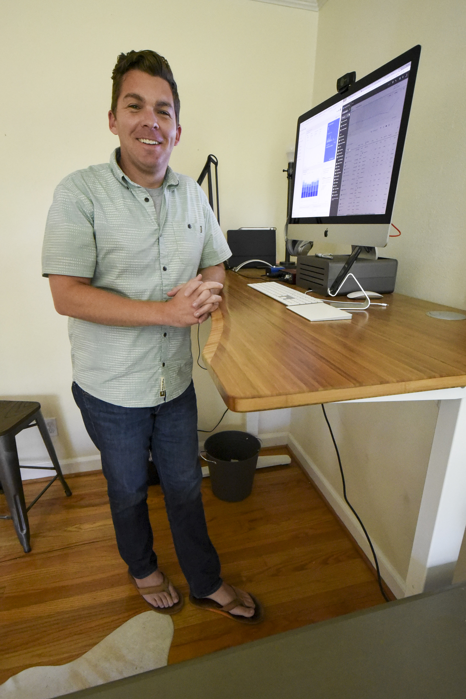 Rob Bettis stands at his desk and performs his marketing work from home in Stuart Heights.