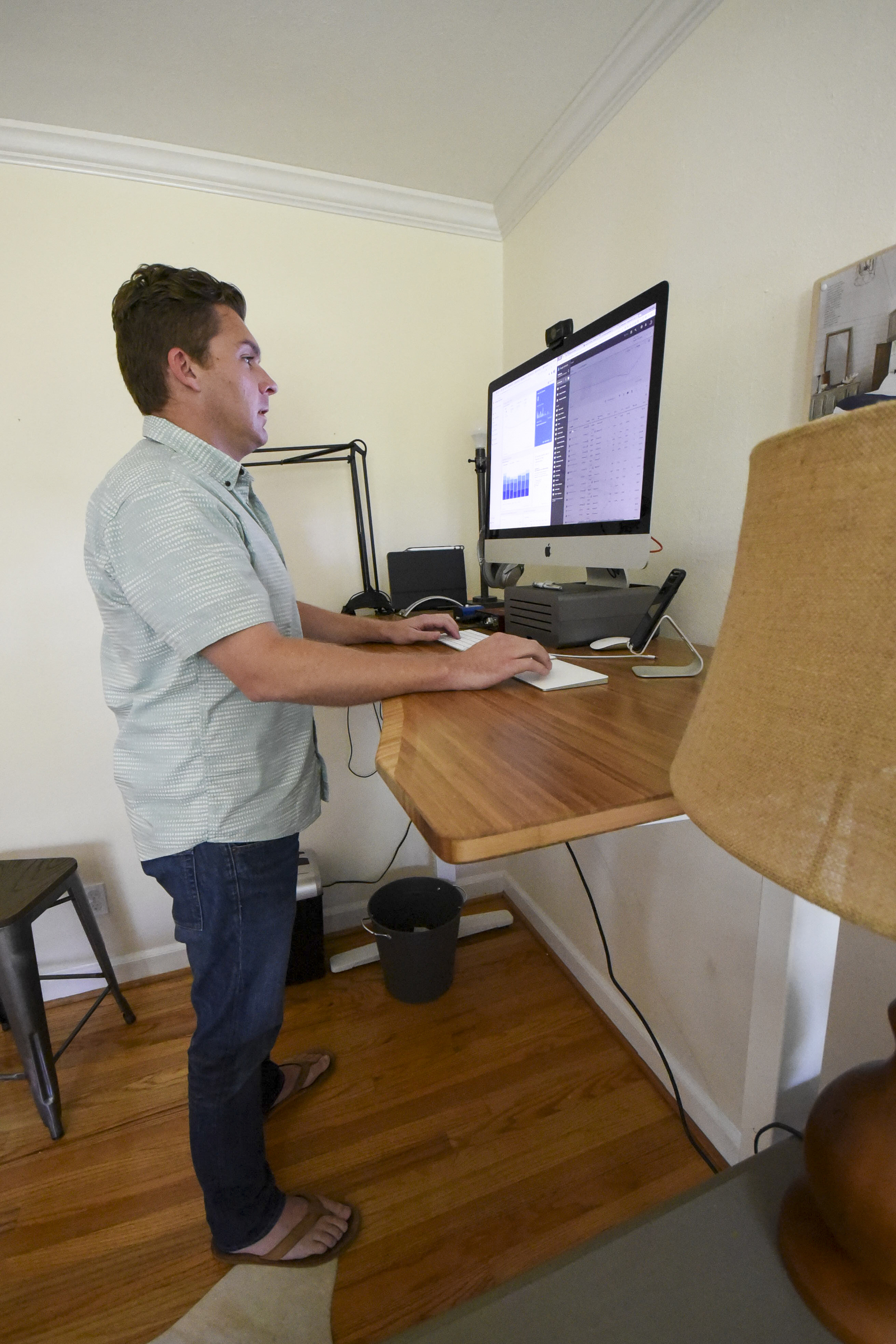 Rob Bettis stands at his desk and performs his marketing work from home in Stuart Heights.