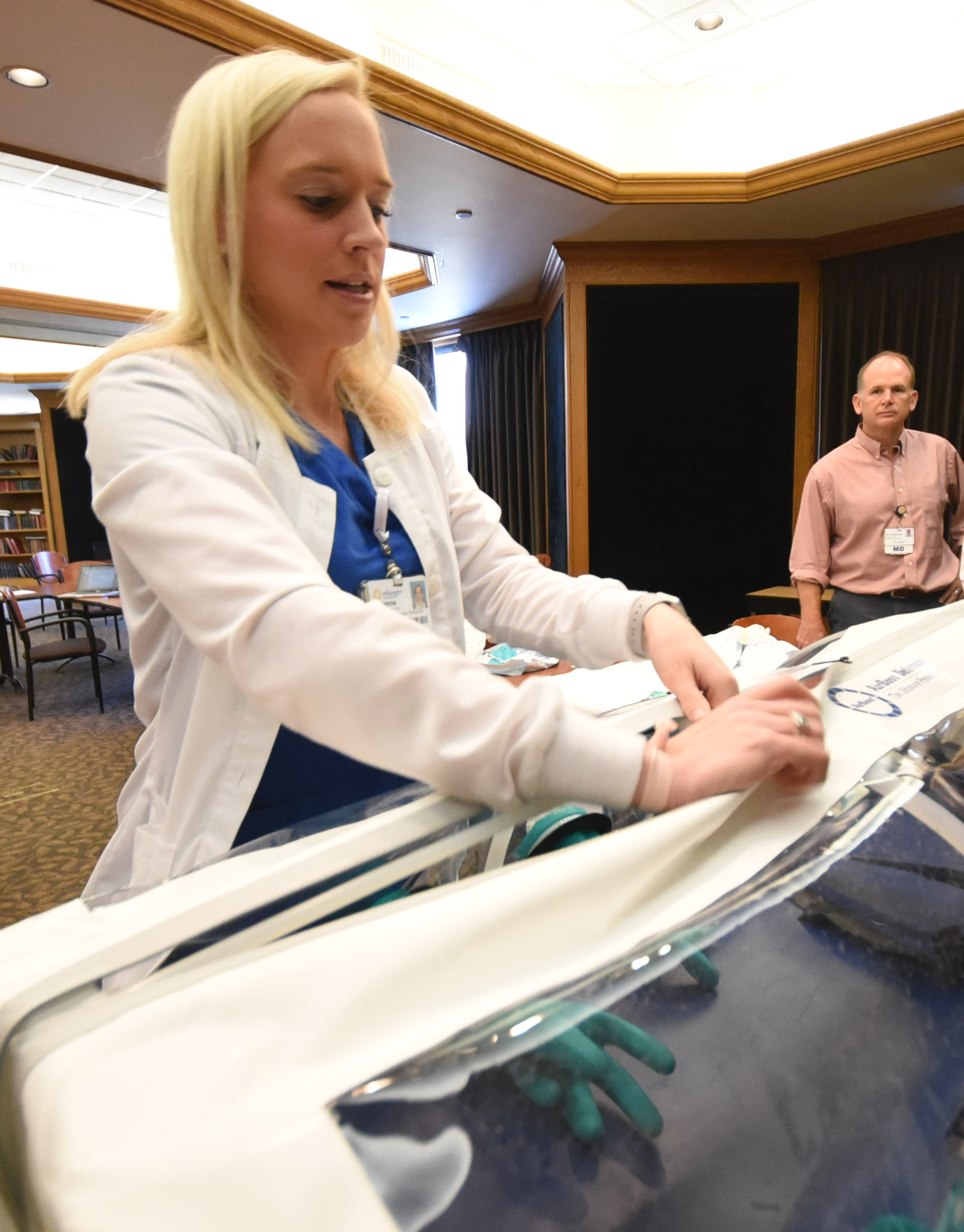 Suzanne Hornsby, team lead for special pathogens at Erlanger, zips the patient containment isolation unit used to transport highly infectious individuals.