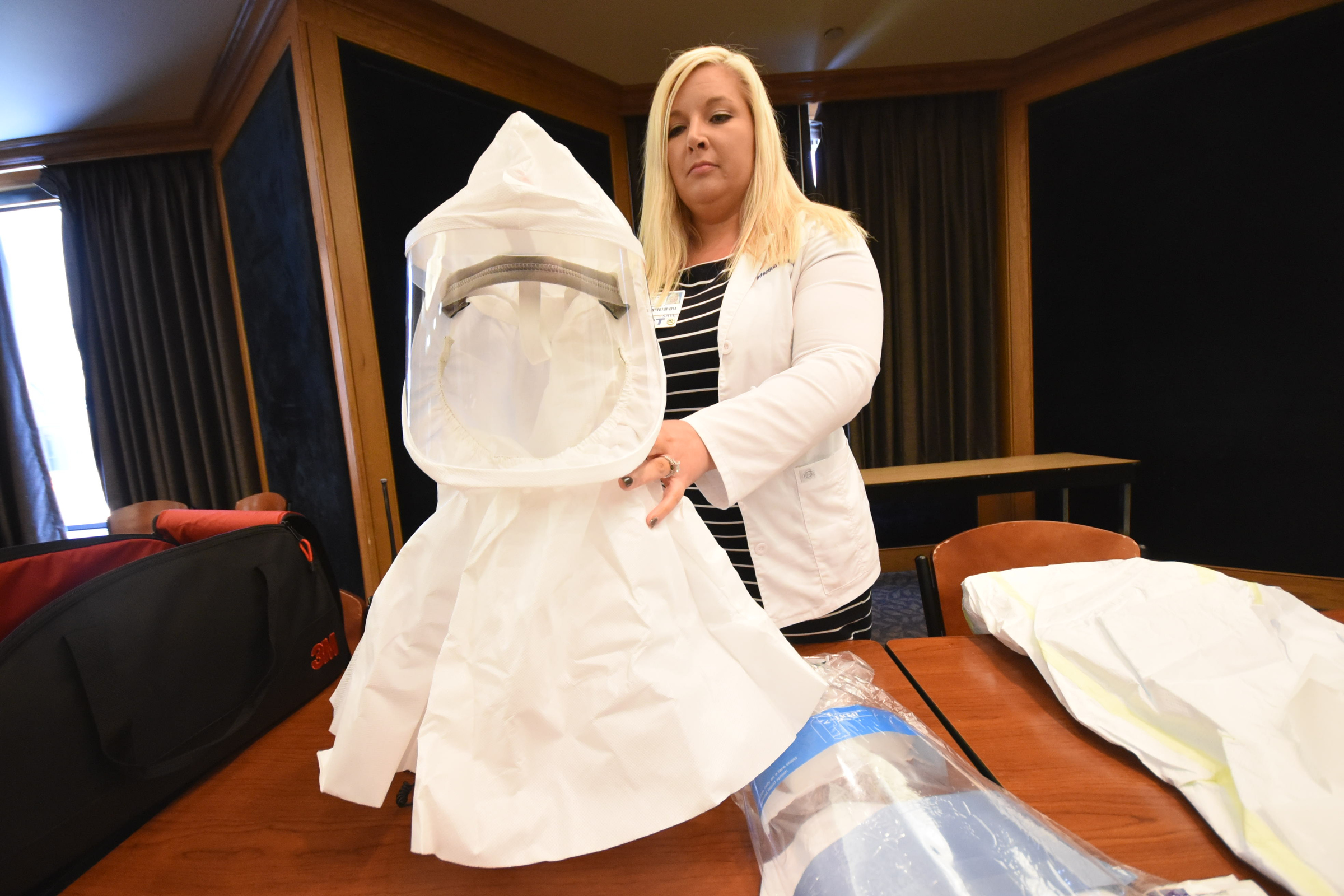 Kristy Headrick, consultant for special pathogens at Erlanger, holds a personal protective equipment hood used for infectious patient care by team personnel.