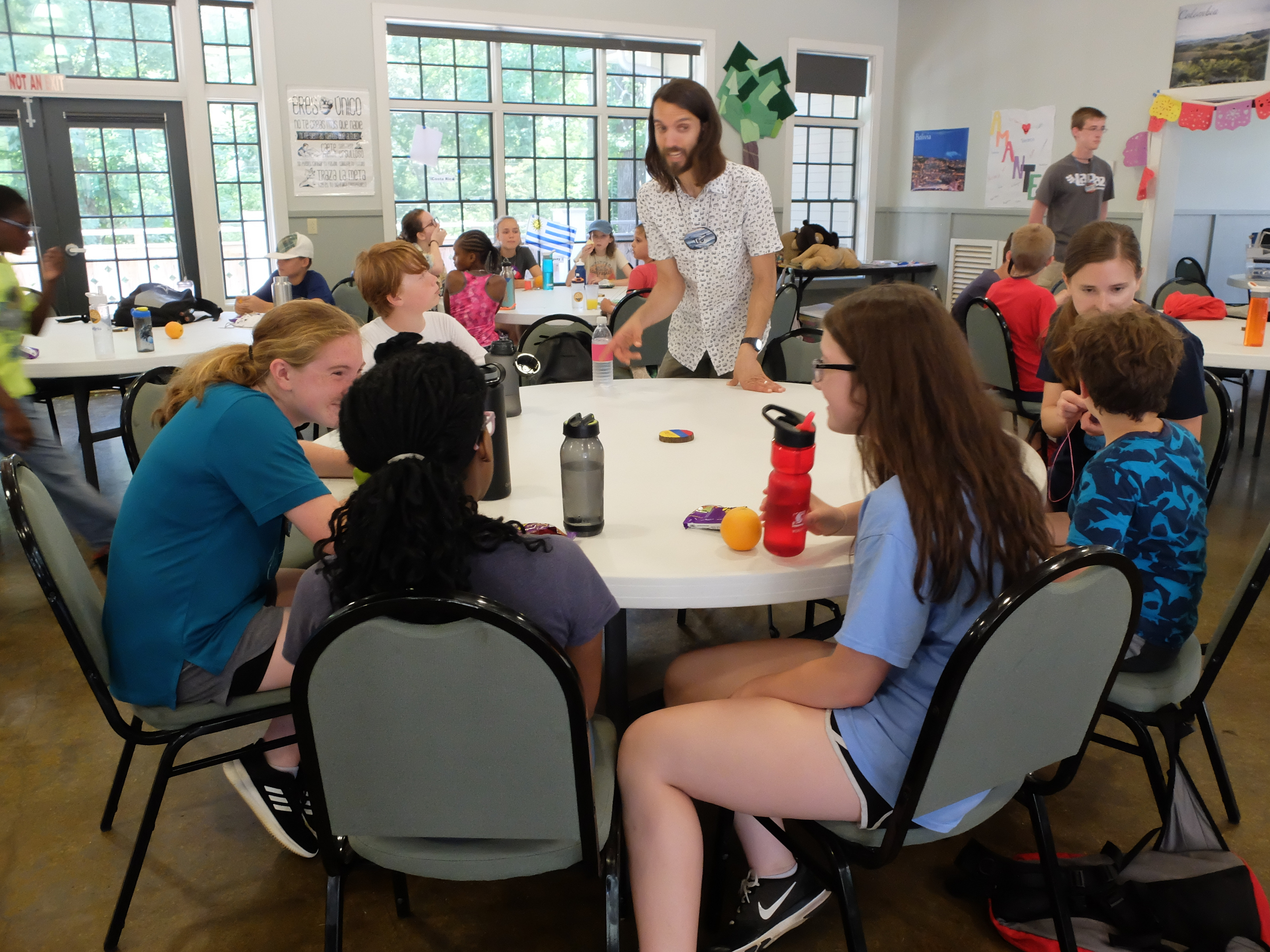 Teo Valdes talks with a group of campers during a snack break Friday at Booker T. Washington State Park. The camp is known as the El Pueblo Spanish Camp.