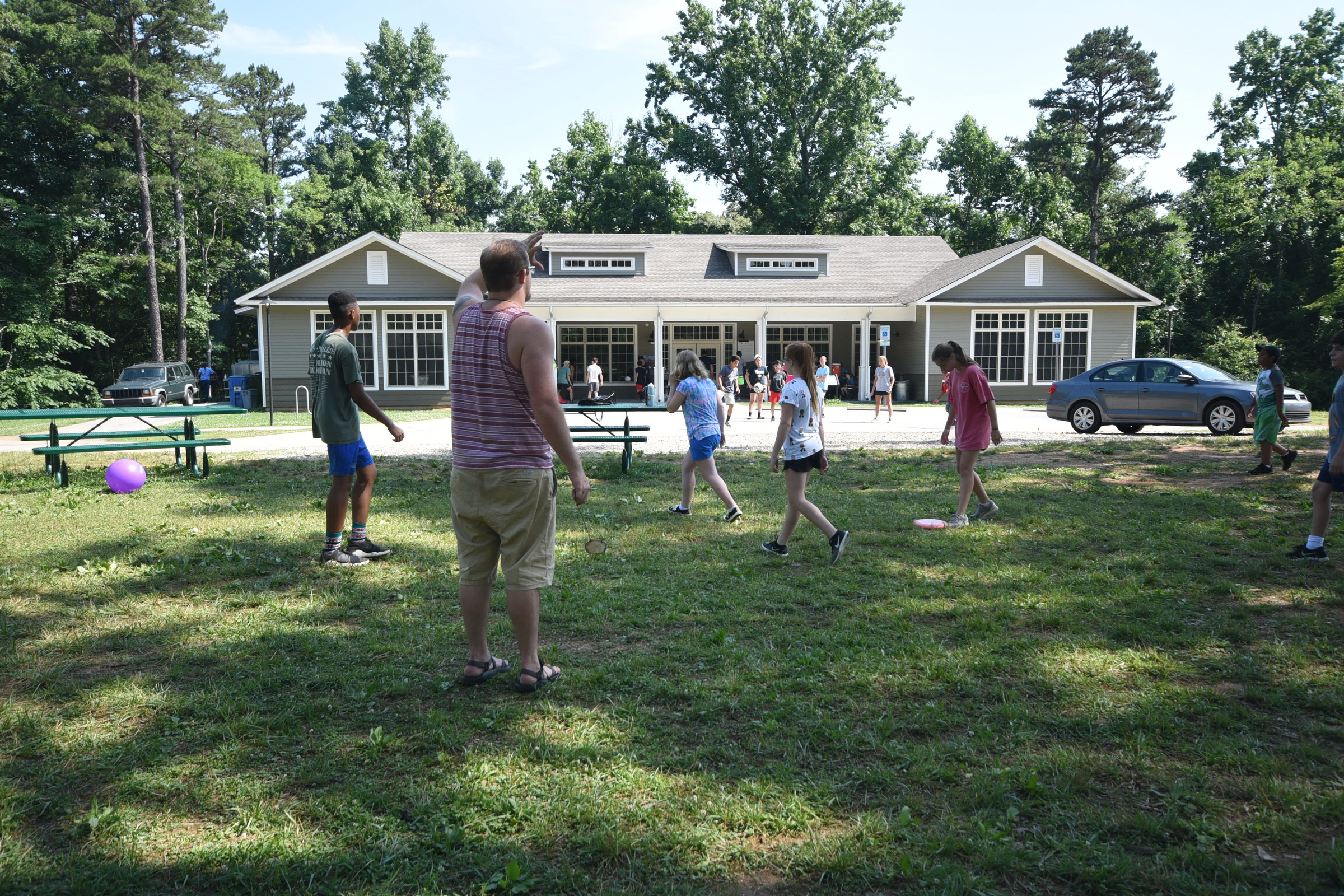 Campers play a flying disc game outside at Spanish immersion camp at Booker T. Washington State Park on Friday.