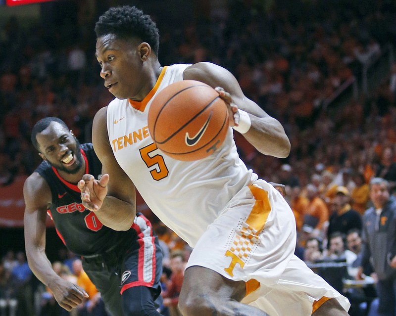 FILE - In this March 3, 2018, file photo, Tennessee forward Admiral Schofield (5) drives the ball toward the basket past Georgia guard William Jackson II (0) in the second half of an NCAA college basketball game in Knoxville, Tenn. Schofield is pulling his name out of the NBA draft and returning to Tennessee for his senior season.  Schofield shared his decision on social media Tuesday, May 29, 2018,  saying he is focused and hungry to once again chase championships with his teammates.   (AP Photo/Crystal LoGiudice, File)