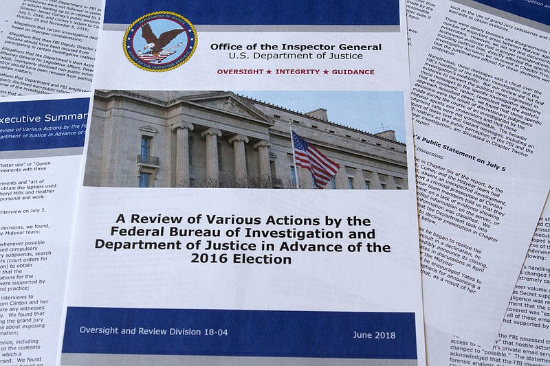 
              Part of the the Department of Justice Inspector General's report after its release in Washington, Thursday, June 14, 2018. The report documented in painstaking detail one of the most consequential investigations in modern FBI history and revealed how the bureau, which for decades has endeavored to stand apart from politics, came to be entangled in the 2016 presidential election.(AP Photo/Jon Elswick)
            