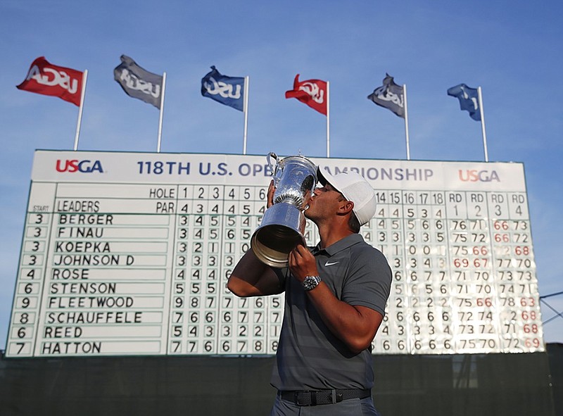 Brooks Koepka kisses the trophy after winning the U.S. Open on Sunday at Shinnecock Hills Golf Club in Southampton, N.Y. Koepka maintained his composure during up-and-down scoring conditions over four days to repeat as the tournament's champion.