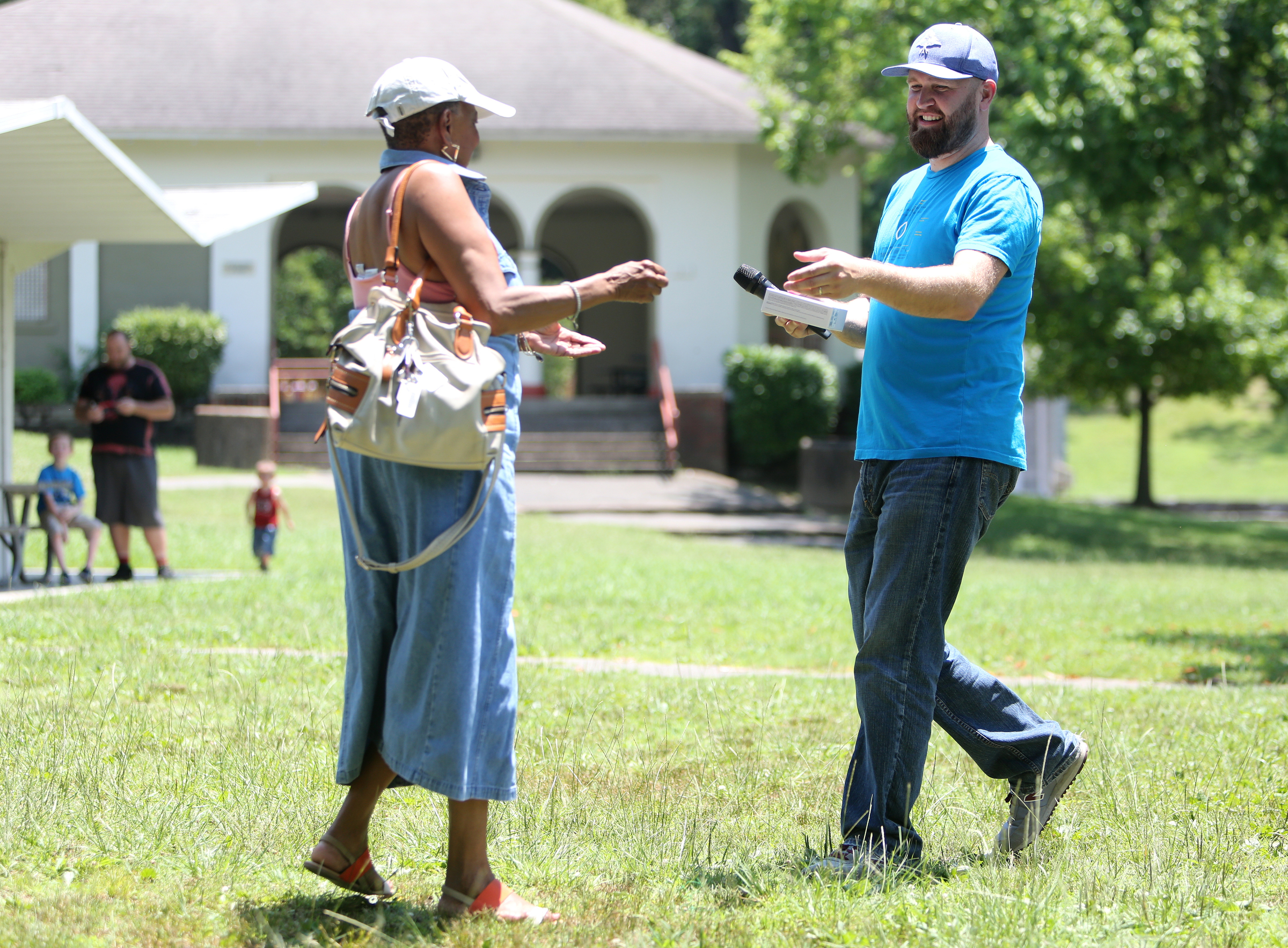 Linda Carter receives a T-Moble G Pad from Sammy Lowdermilk after winning a raffle at a Tech Goes Home celebration Sunday, June 17, 2018 at East Lake Park in Chattanooga, Tennessee. A variety of raffle prizes were given out during the event including give cards, tablets and laptops.