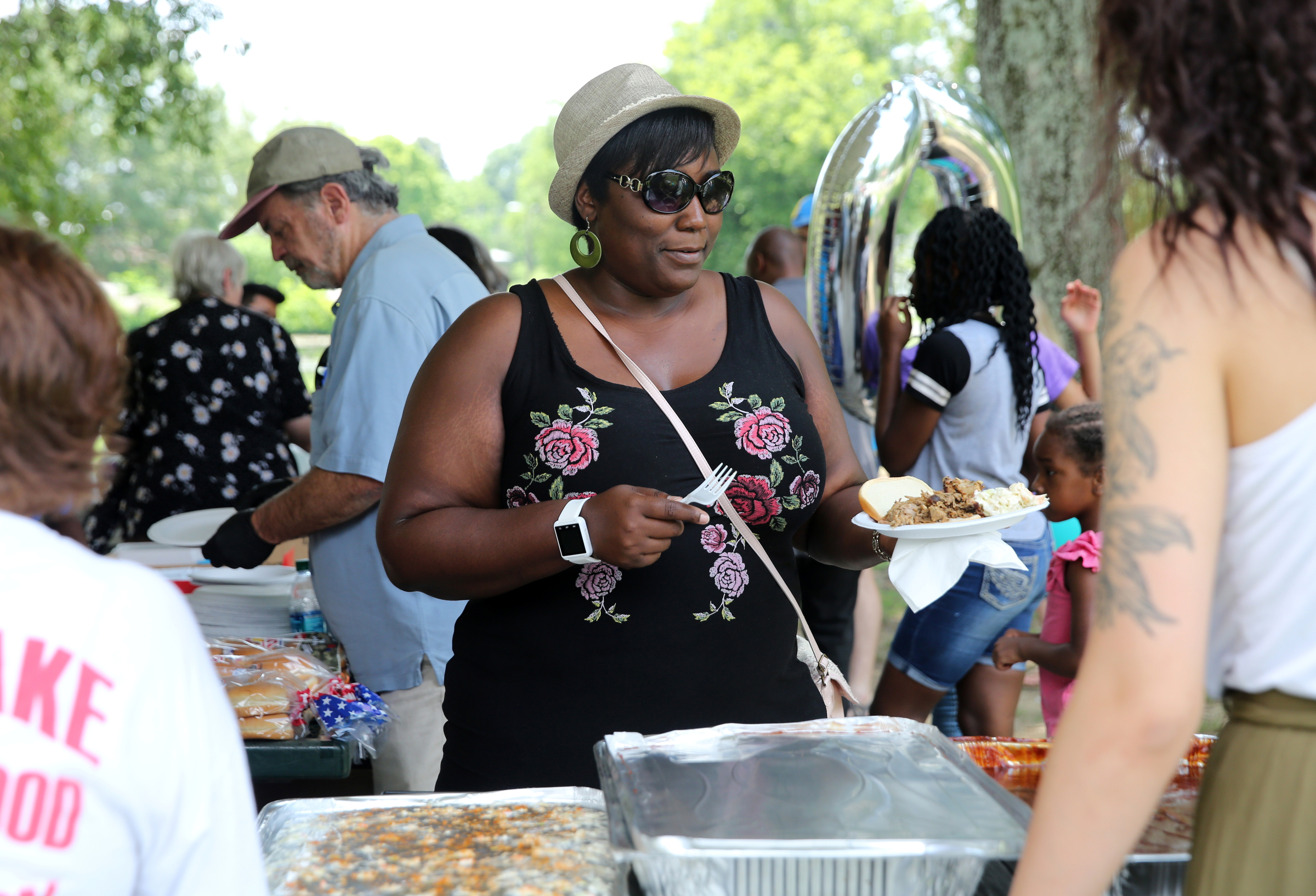 Raquetta Dotley gets food during a Tech Goes Home celebration Sunday, June 17, 2018 at East Lake Park in Chattanooga, Tennessee. Dotley was one of the 3,000 individuals to graduate from Tech Goes Home.