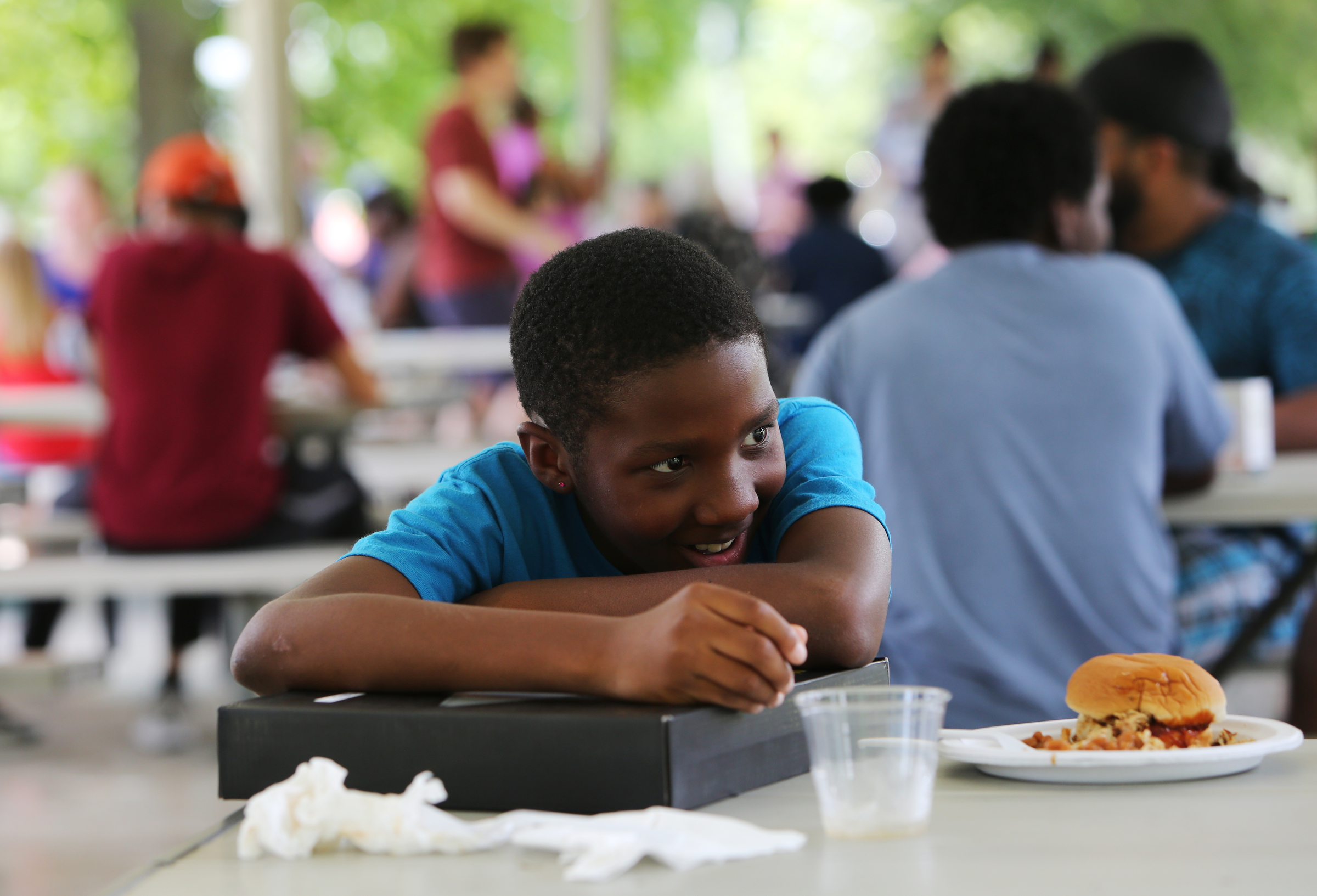 Andrew Crowder grins as he hugs a raffle prize he won Sunday, June 17, 2018 during a Tech Goes Home celebration at East Lake Park in Chattanooga, Tennessee. Crowder won a Fusion 5 laptop.