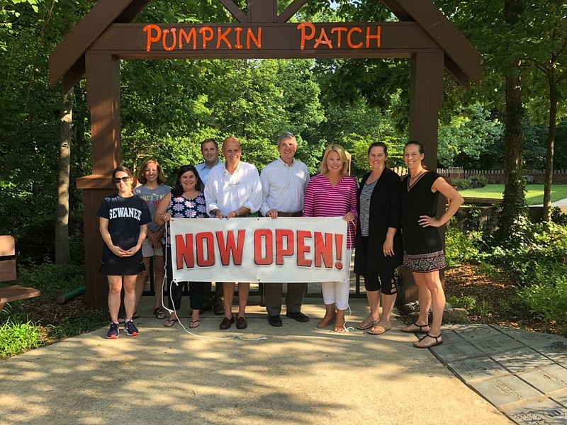 Volunteers who worked to rebuild the Pumpkin Patch gather with Walden town officials at the entrance to the 20-year-old playground, which recently reopened after being closed for reconstruction for the past seven months. From left are Katie Chapman, Bailey Hale, Kendall Brown, John Barlew, Bill Trohanis, Lee Davis, Cory Phillips, Kate Harwood and Lindsay Wolford. (Contributed photo)