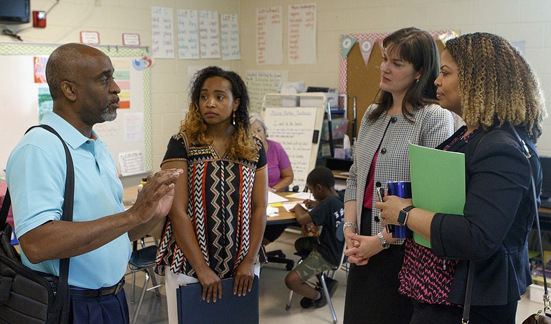 Partnership Network advisory board member Wayne Brown, left, talks with fellow board members Dakasha Winton, left center, Valoria Armstrong, right, and Education Commissioner Candice McQueen, center right, while touring the Read to be Ready program at Orchard Knob Elementary School on Monday, June 18, 2018 in Chattanooga, Tenn.