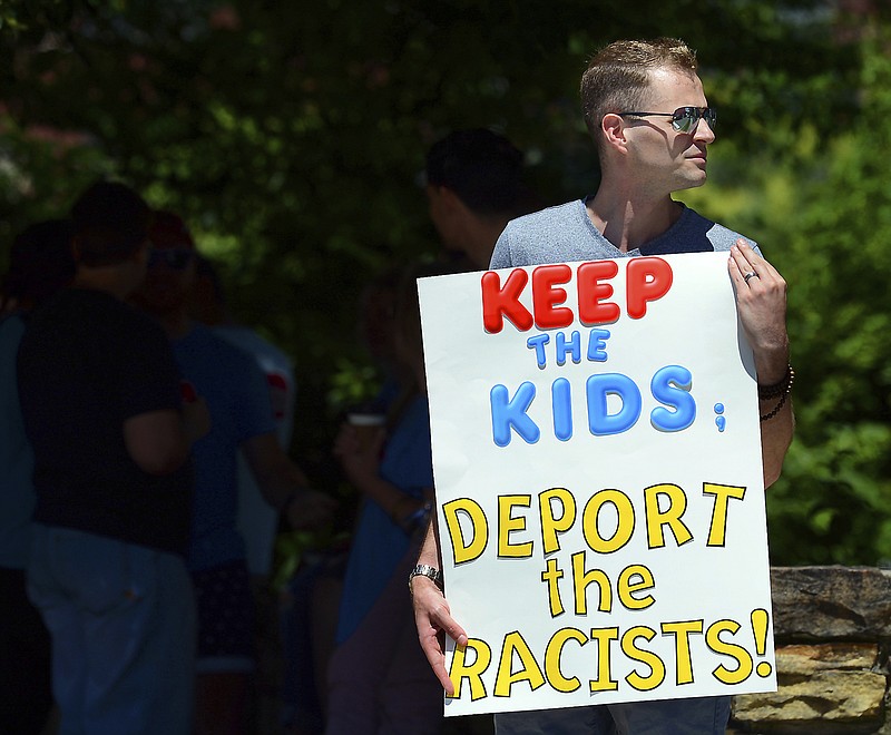 FILE - In this June 15, 2018 file photo, Chris Olson, of Lake Wallenpaupack, Pa., holds a sign outside Lackawanna College where U.S. Attorney Jeff Sessions spoke on immigration policy and law enforcement actions. The Trump administration's move to separate immigrant parents from their children on the U.S.-Mexico border has turned into a full-blown crisis in recent weeks, drawing denunciation from the United Nations, Roman Catholic bishops and countless humanitarian groups. (Butch Comegys/The Times-Tribune via AP, File)