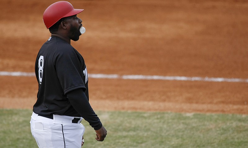 Lookouts manager Tommy Watkins (8) blows a bubble on opening day against the Birmingham Barons at AT&T Field on Thursday, April 5, 2018 in Chattanooga, Tenn.