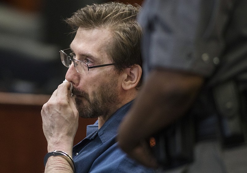 
              Jeffrey Willis wipes tears from his face after speaking to the courtroom before being sentenced to life in prison without parole for the 2013 murder and kidnapping of Jessica Heeringa on Monday, June 18, 2018, at the Muskegon County Courthouse in Muskegon, Mich. In November of 2017 Willis was found guilty of murdering Rebekah Bletsch in April of 2014. (Joel Bissell/Muskegon Chronicle via AP)
            