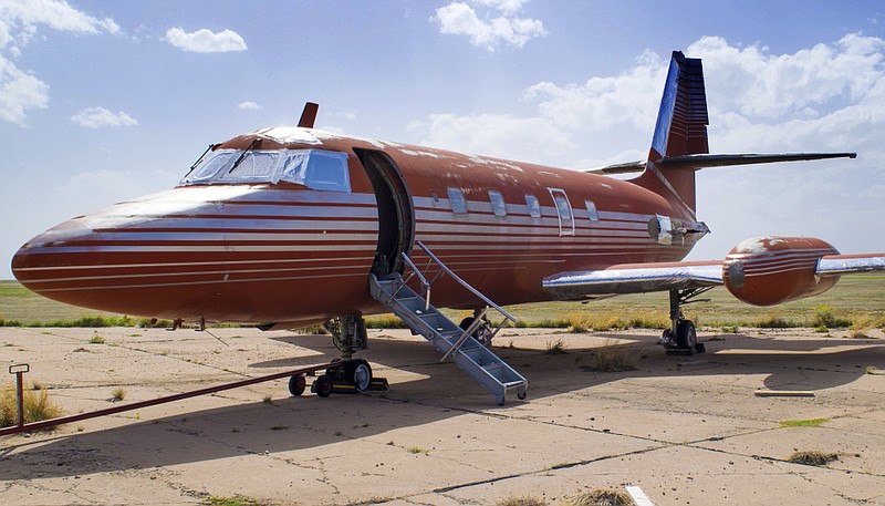 FILE - This undated file photo provided by GWS Auctions, Inc. shows a private jet once owned by Elvis Presley, on a runway in New Mexico. 