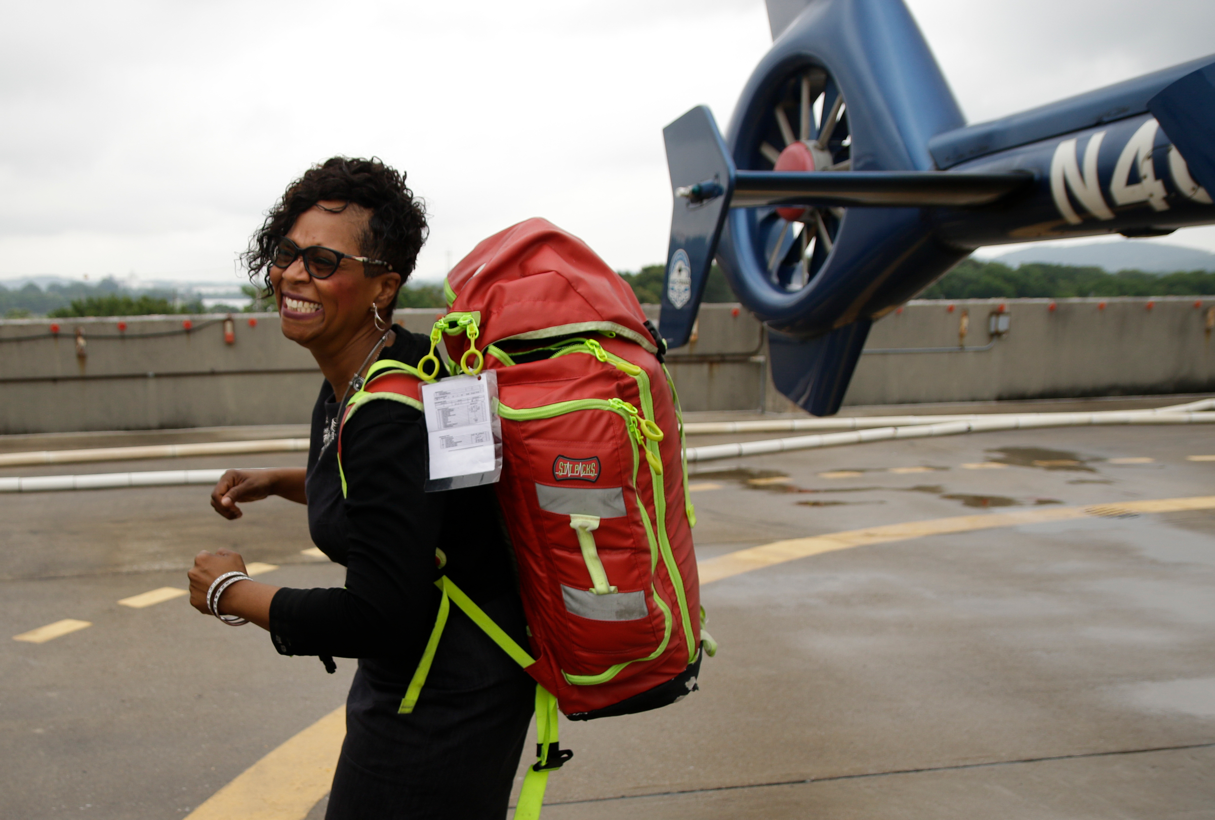 Howard principal Leandrea Ware tries out a Life Force equipment pack while touring the helipad at Erlanger Hospital on Wednesday, June 13, 2018, in Chattanooga, Tenn. Teachers from Howard and other schools which will launch Future Ready Institutes in the fall spent the week participating in externships at business partners across the region.