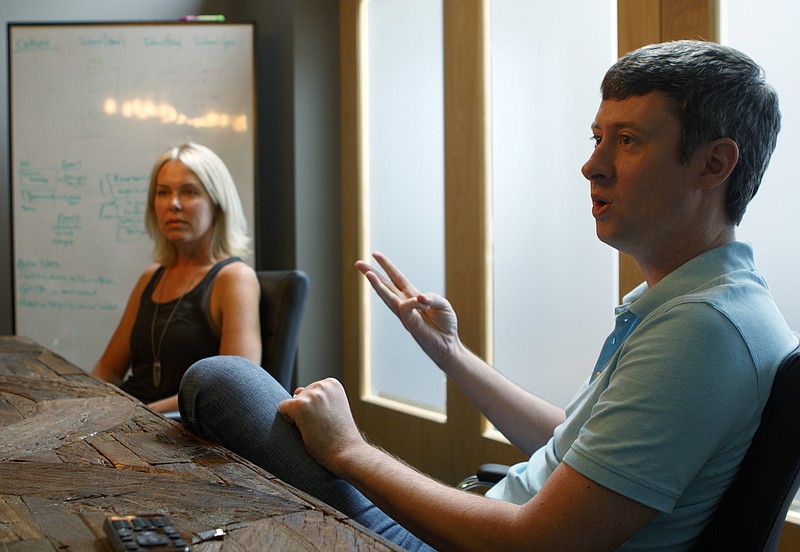 Staff photo by C.B. Schmelter / As fellow co-founder Jamey Elrod looks on, Rob Reagan speaks to the Times Free Press at the Text Request office on Monday, June 4, 2018.