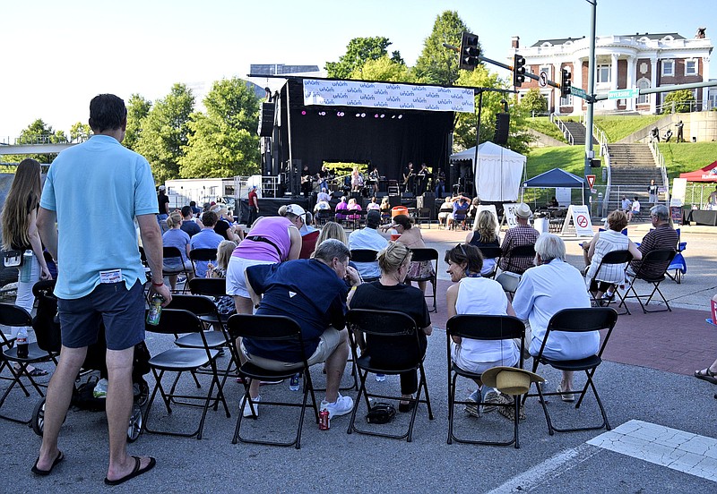 Patrons find the shade as Rock Candy plays on the Unum Stage below the Hunter Museum of American Art at the Riverbend Festival on June 15.