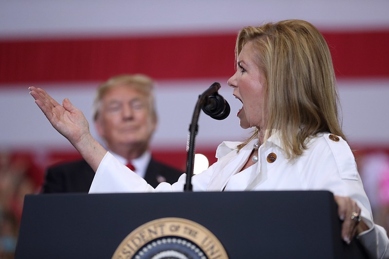 Rep. Marsha Blackburn, R-Tenn., speaks as President Donald Trump listens at a rally Tuesday, May 29, 2018, in Nashville, Tenn. (AP Photo/Andrew Harnik)