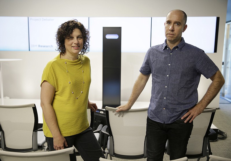 Dr. Ranit Aharonov, manager, left, and Dr. Noam Slonim, right, principal investigator, right, pose for a photo in front of the IBM Project Debater before a debate between the computer and two human debaters Monday, June 18, 2018, in San Francisco.