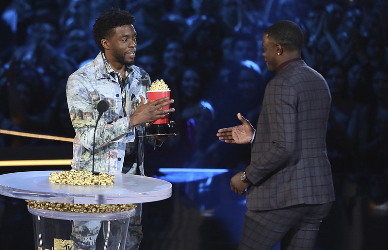 In this Saturday, June 16, 2018, photo, Chadwick Boseman, left, gives his best hero award for his role in "Black Panther" to James Shaw Jr., who is credited with saving lives during a shooting at a Waffle House in Antioch, Tenn., at the MTV Movie and TV Awards at the Barker Hangar in Santa Monica, Calif. (Photo by Matt Sayles/Invision/AP)

