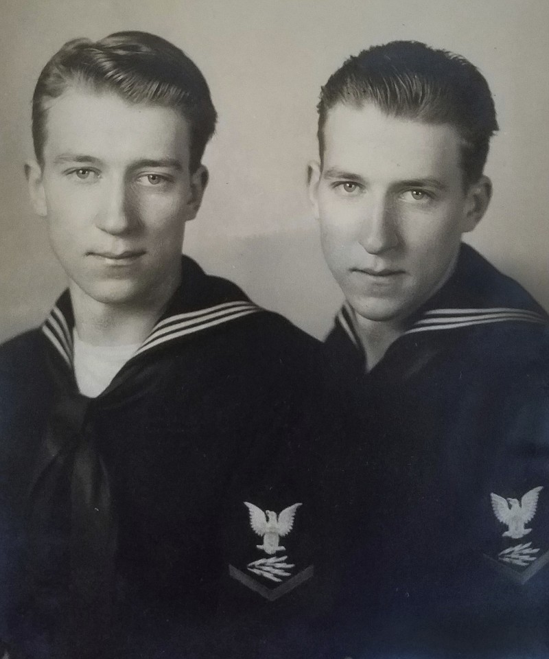 In this undated photo, provided by family member Susan Lawrence on Wednesday, June 13, 2018, twin brothers Julius Pieper, left, and Ludwig Pieper in their U.S. Navy uniforms. For decades, he had a number for a name, Unknown X-9352, at a World War II American cemetery in Belgium where he was interred. On Tuesday, June 19, 2018, Julius Pieper will be reunited with his twin brother in Normandy, where the two Navy men died together when their ship shattered on an underwater mine while trying to reach the blood-soaked D-Day beaches. (Susan Lawrence via AP)