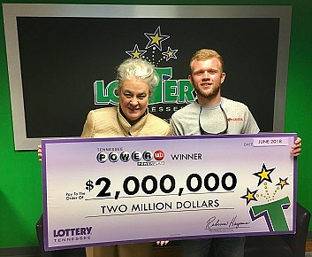 Tennessee Lottery President Rebecca Hargrove, left, stands with Matthew Reed, of Shelbyville, Tennessee, who won a $2 million Powerball prize Saturday, June 19.