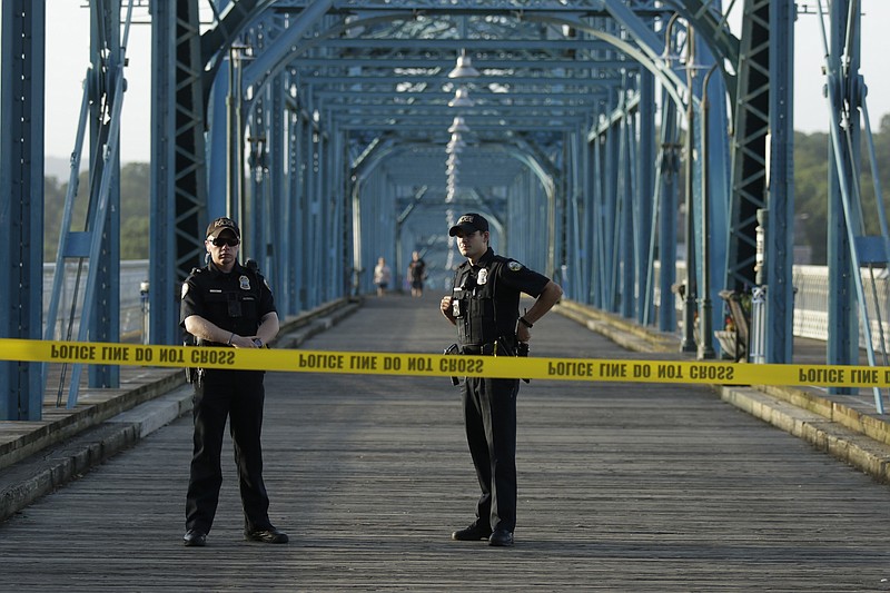 Chattanooga police respond to the Walnut Street Bridge where they said a person had climbed on top of the bridge supports on Tuesday, June 19, 2018. 