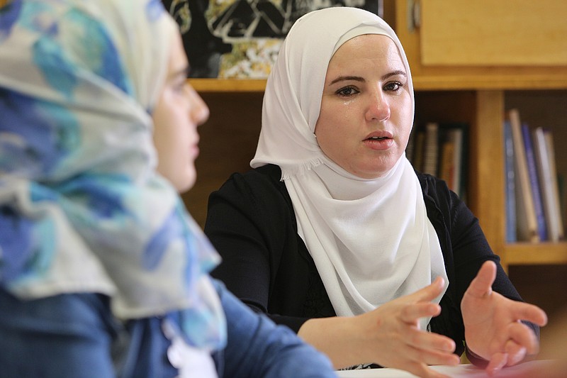 Faihaa Fuyome gets emotional as she talks about her house in Syria being destroyed by a bomb just two hours after she and her family left for Jordan at Bridge Refugee Services Monday, June 18, 2018 in Chattanooga, Tennessee. Fuyome said that if her children had not convinced her that they needed to leave for their safety, they would likely have been seriously injured or dead.