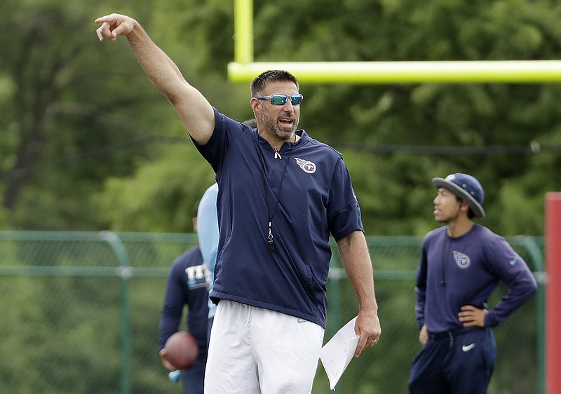 Tennessee Titans coach Mike Vrabel speaks to players as they warm up for a minicamp session June 13 in Nashville. The team is on a break before reporting for preseason camp in late July, when preparation will start in earnest for Vrabel's first year as a head coach.