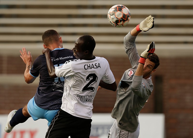 Chattanooga FC's Charles Clarke, left, heads the ball toward Atlanta Silverbacks goalkeeper Theo Blachon, right, during their NPSL Southeast Conference match Wednesday night at Finley Stadium. CFC scored four goals in a 15-minute span of the second half to rally from a 1-0 deficit and win.