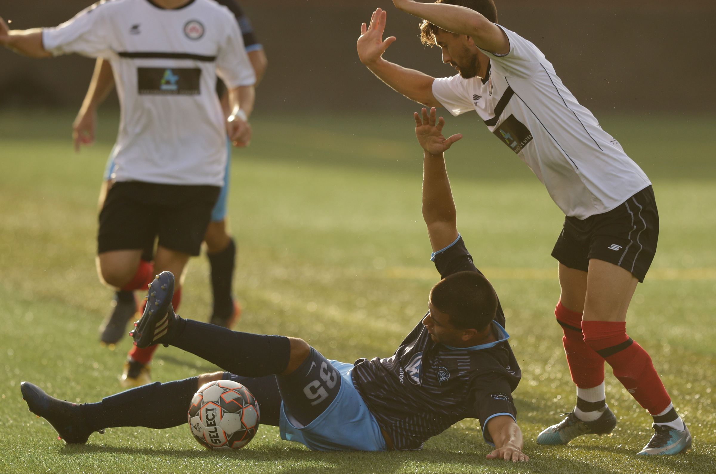 CFC's Santiago Moore flails on the ground after being forced down by Atlanta's Manuel Moreno Yeste during Chattanooga FC's soccer match against the Atlanta Silverbacks at Finley Stadium on Wednesday, June 20, 2018, in Chattanooga, Tenn.