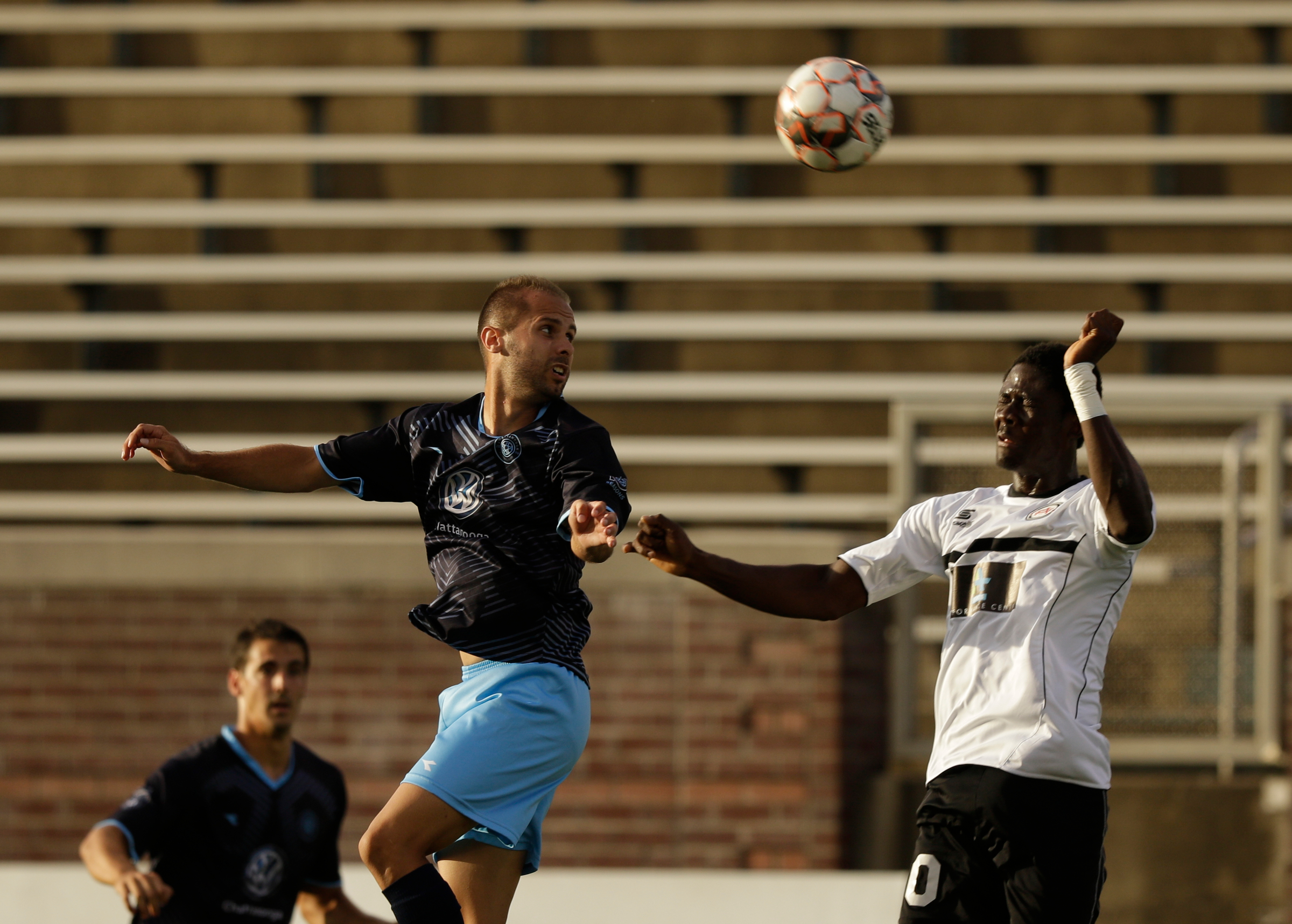 CFC's Joao Costa, left, heads the ball against Atlanta's Dionysius Harmon during Chattanooga FC's soccer match against the Atlanta Silverbacks at Finley Stadium on Wednesday, June 20, 2018, in Chattanooga, Tenn.