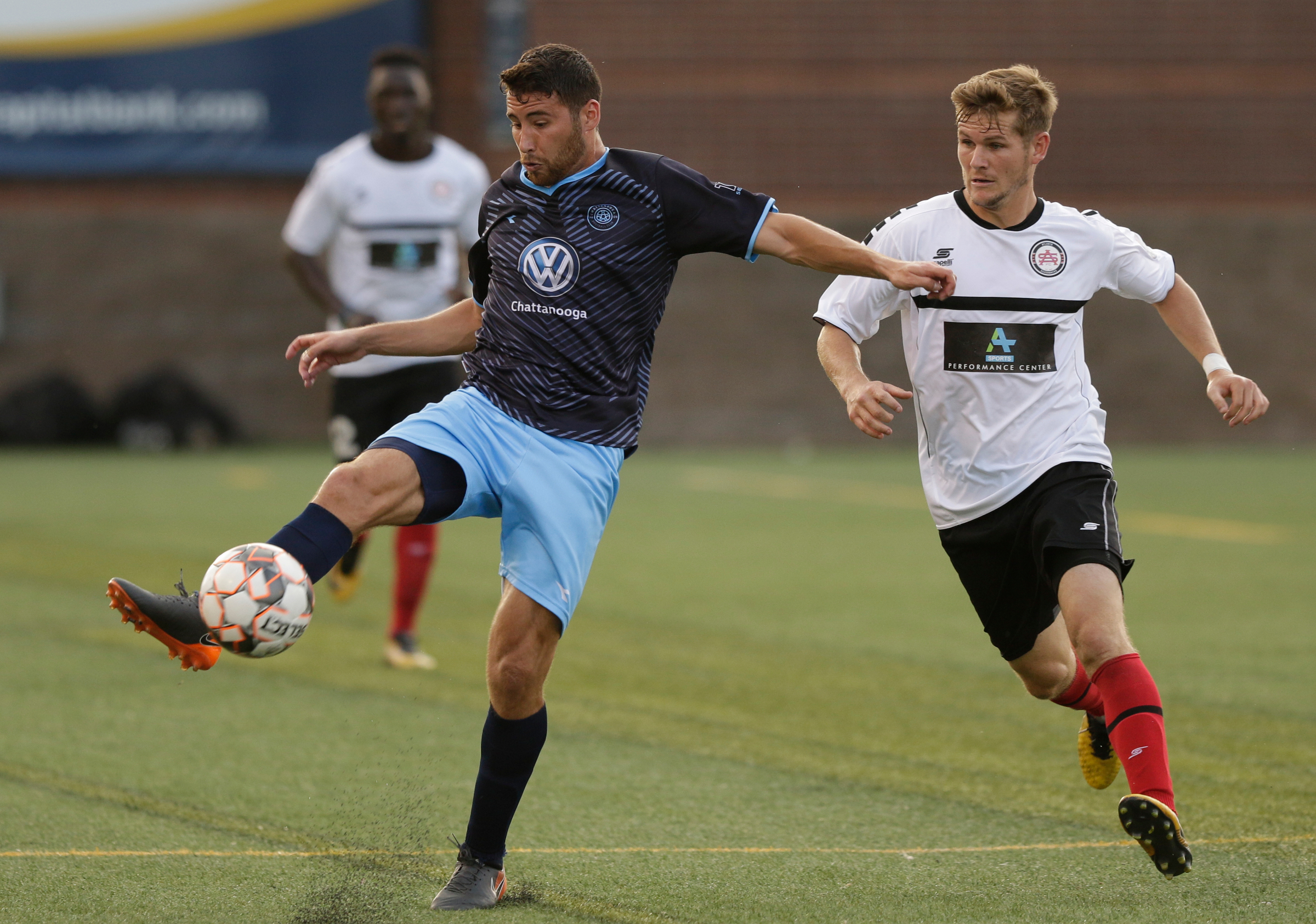 CFC's Pablo Gaona takes a shot on the goal around Atlanta's Aaron Walker during Chattanooga FC's soccer match against the Atlanta Silverbacks at Finley Stadium on Wednesday, June 20, 2018, in Chattanooga, Tenn.