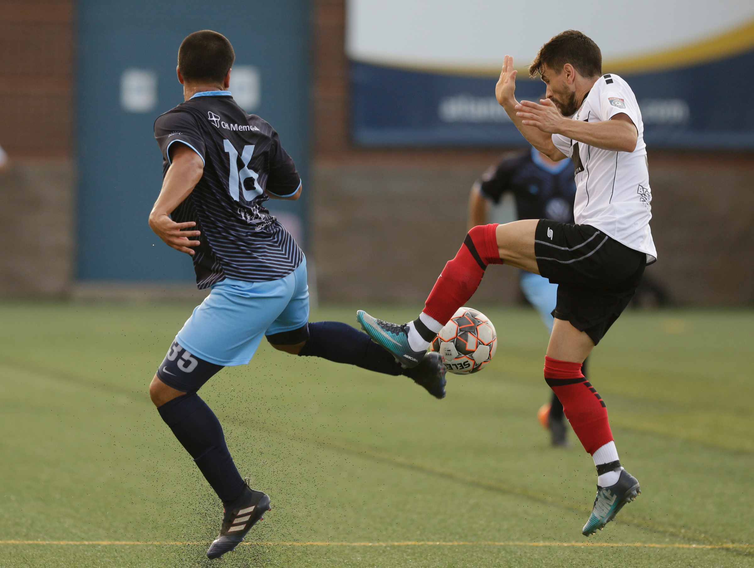 CFC's Santiago Moore, left, tries to field a deep kick against Atlanta's Manuel Moreno Yeste during Chattanooga FC's soccer match against the Atlanta Silverbacks at Finley Stadium on Wednesday, June 20, 2018, in Chattanooga, Tenn.