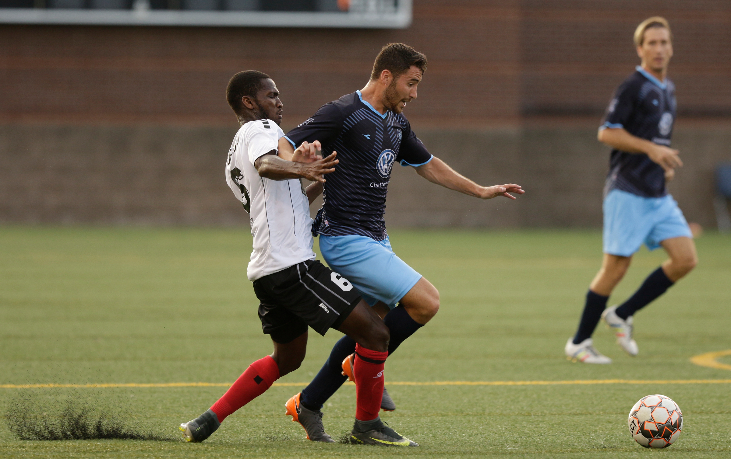 CFC's Pablo Gaona is tackled by Atlanta's Kebba Demba during Chattanooga FC's soccer match against the Atlanta Silverbacks at Finley Stadium on Wednesday, June 20, 2018, in Chattanooga, Tenn.