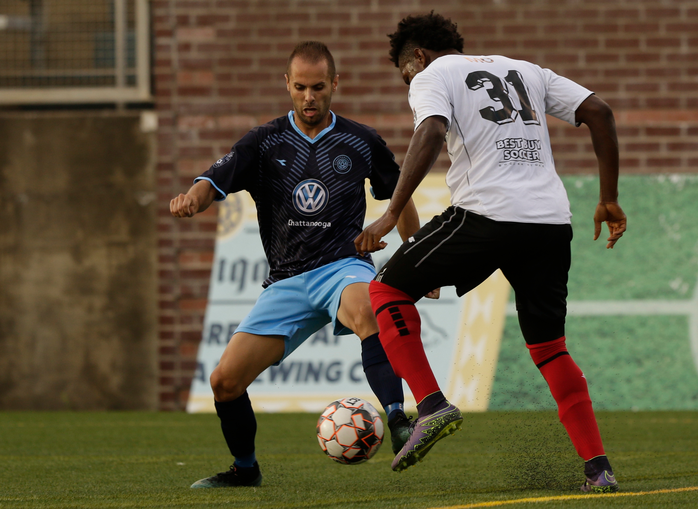 CFC's Joao Costa tries to find room around Atlanta's Kevin Issahaku during Chattanooga FC's soccer match against the Atlanta Silverbacks at Finley Stadium on Wednesday, June 20, 2018, in Chattanooga, Tenn.